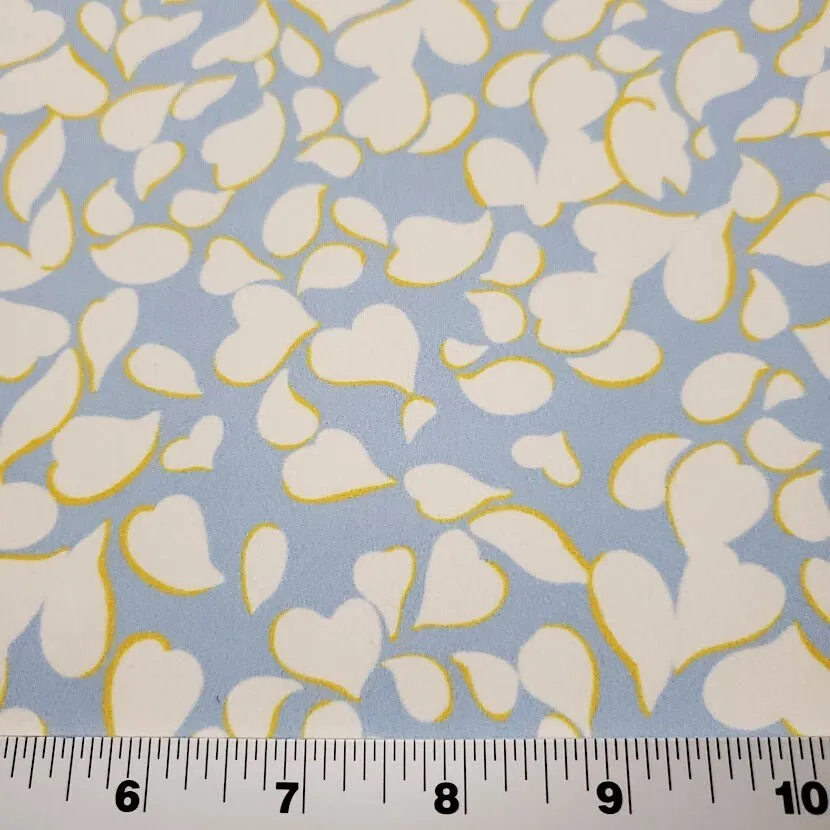 Swimwear Fabric: Nylon Spandex Knit, Pretty Blue with White and Yellow Print. Nice Quality Activewear and Swim Fabric. Sold by the 1/2 yard
